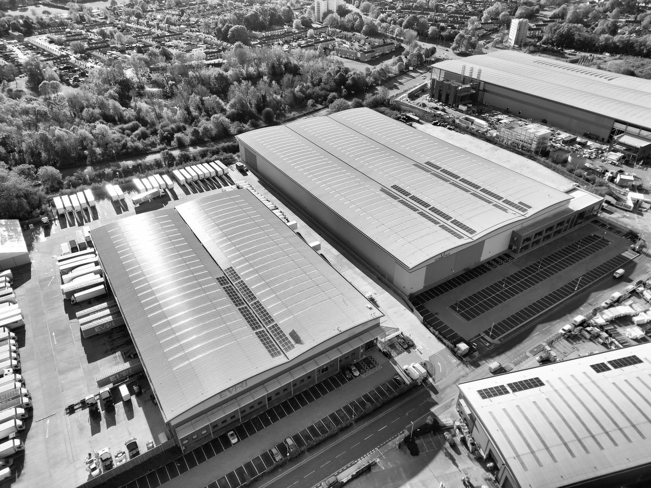 Free Aerial monochrome image of industrial warehouses and parking spaces in Hertfordshire, UK. Stock Photo