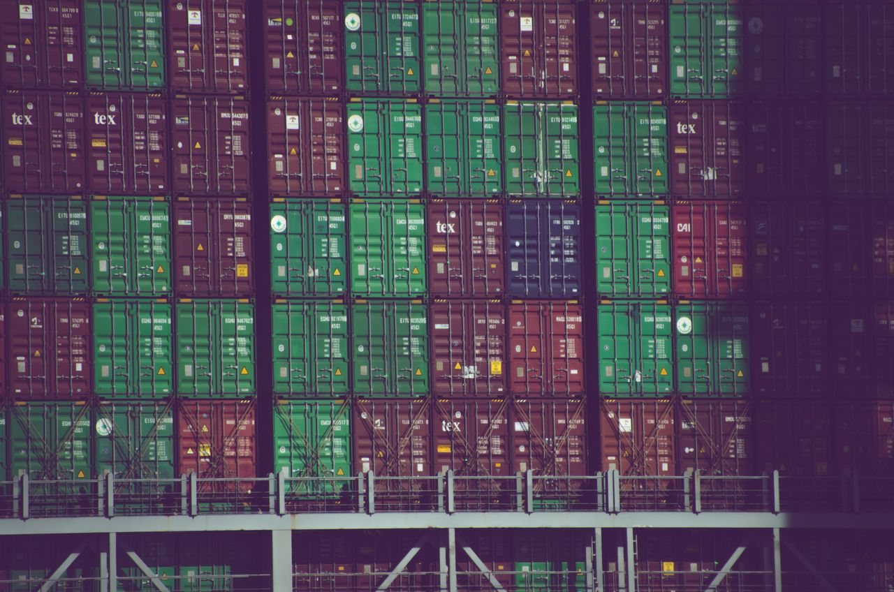 Free Vibrant cargo containers stacked at Hamburg port, Germany, showcasing global trade. Stock Photo